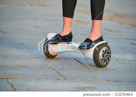 Female legs riding gyroscooter. 31078464
