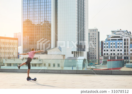 Guy on hoverboard, city. 31078512