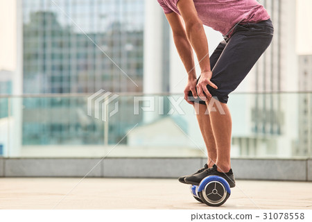 Guy on gyroscooter outdoors. 31078558