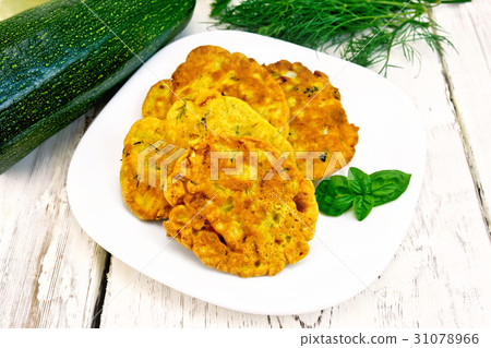 Flapjack chickpeas with zucchini in plate on board Flapjack chickpeas with zucchini in plate on board 31078966