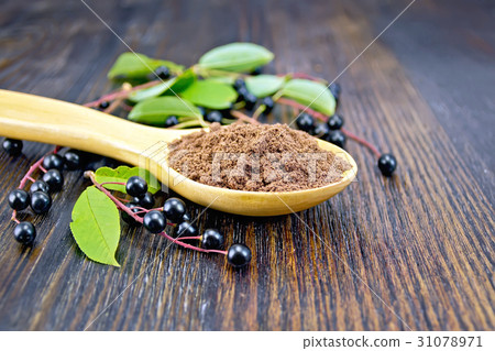 Flour bird cherry in spoon with berries on board Flour bird cherry in spoon with berries on board 31078971