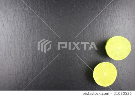 fresh lime fruit on a slate plate food background 31080525
