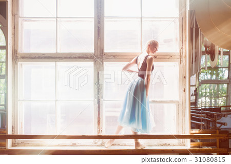 Ballerina is dancing in front of a large window Ballerina is dancing in front of a large window 31080815