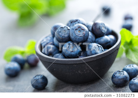 Fresh Blueberries in a bowl on dark background Fresh Blueberries in a bowl on dark background 31082273
