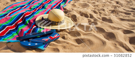 towel and sunbathing accessories on sandy beach 31082852