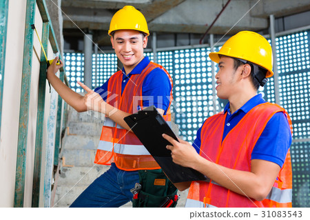 worker controlling building on construction site worker controlling building on construction site 31083543
