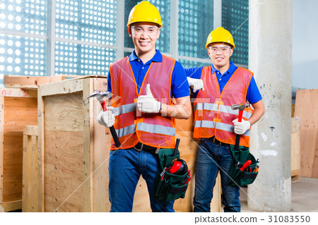 Construction worker close a wood box Construction worker close a wood box 31083550