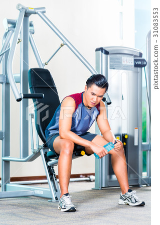 Portrait of young man sitting at the gym Portrait of young man sitting at the gym 31083553