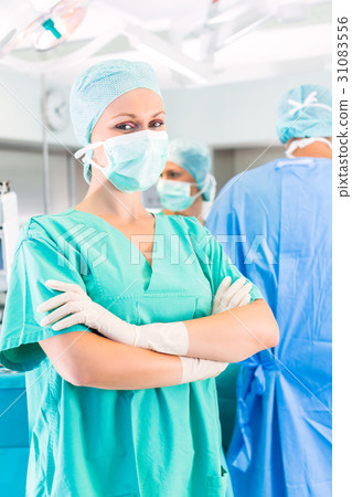 Surgeons operating patient in operation theater 31083556