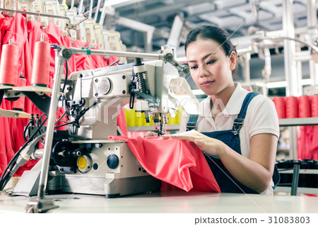 Chinese seamstress working in textile factory 31083803