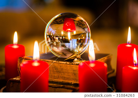 Crystal ball in the candle light to prophesy 31084263