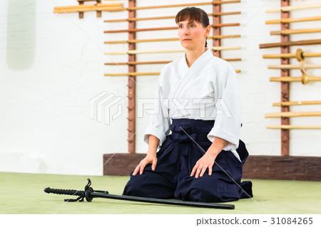 Woman at Aikido martial arts with sword 31084265