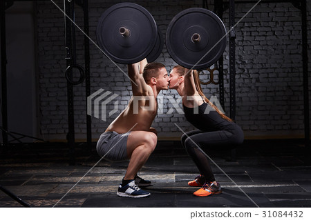 Young beautiful sportive woman and man kissing and 31084432