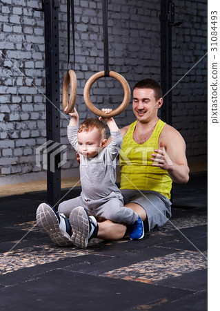Smiling young father trains the little son with 31084493