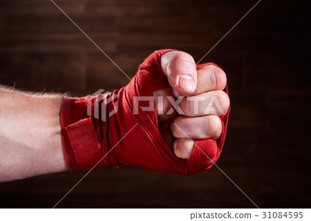 Close up image of fist of a boxer with red bandage Close up image of fist of a boxer with red bandage 31084595