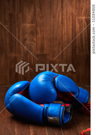 Boxing background with blue gloves and red bandage Boxing background with blue gloves and red bandage 31084808