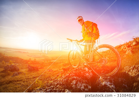 low angle view of cyclist standing with mountain 31084829