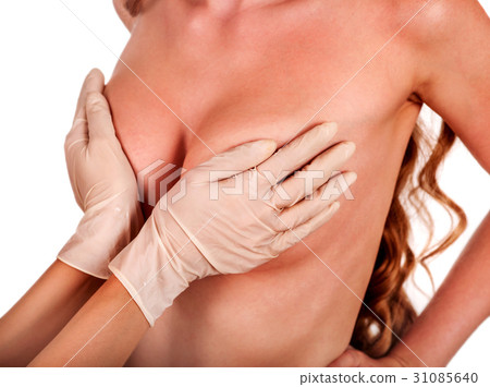Female breast augmentation. Doctor hands wearing 31085640