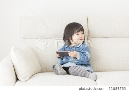 A girl watching a smartphone A girl watching a smartphone 31085763