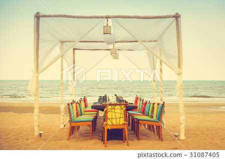 Table and chair set on the beach for dinner Table and chair set on the beach for dinner 31087405