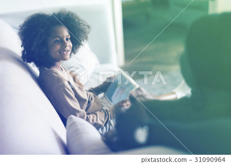 Little african girl using digital tablet Little african girl using digital tablet 31090964