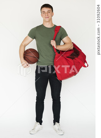 Mucsular sportsman holding basketball smiling casual studio portrait 31092604