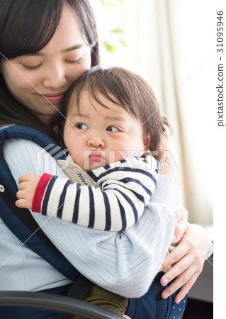A mother holding a baby 31095946