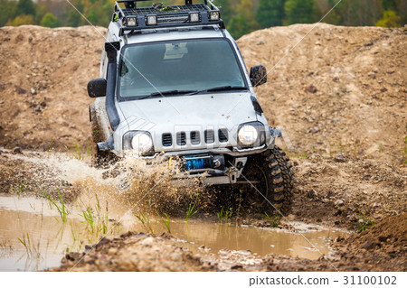 Suzuki Jimny moving by water in autumn Suzuki Jimny moving by water in autumn 31100102