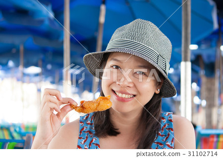 Woman eating seafood 31102714