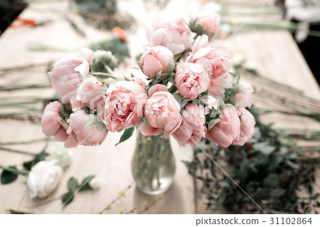 Pink peonies in vase on wooden floor and bokeh 31102864