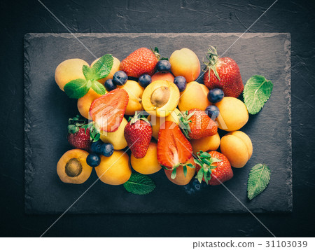 Heap of apricot and berries, top view 31103039
