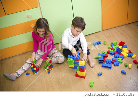 Children playing with construction toy blocks Children playing with construction toy blocks 31103192