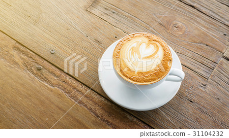 Hot coffee on a wooden table. Hot coffee on a wooden table. 31104232