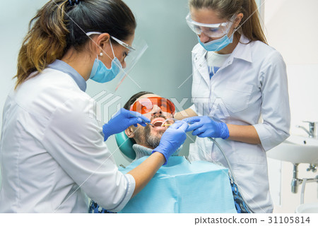 Two female dentists at work. Two female dentists at work. 31105814