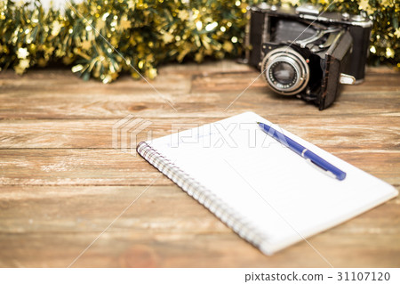 wooden background with notebook, pen and camera wooden background with notebook, pen and camera 31107120