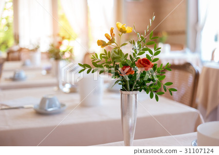 Vase with flowers and leaves. 31107124