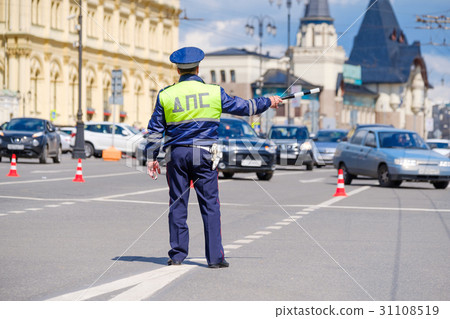 Traffic policeman works on a street at day time Traffic policeman works on a street at day time 31108519