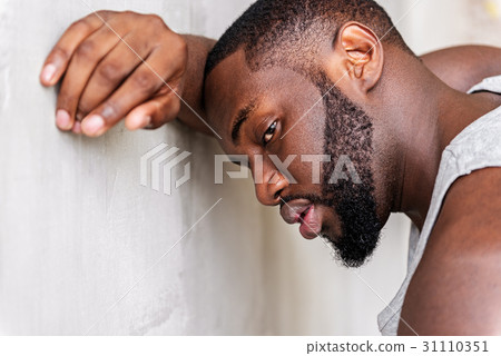 Tired young african sportsman having recreation Tired young african sportsman having recreation 31110351