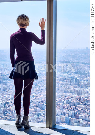 Young woman in the window 31111280