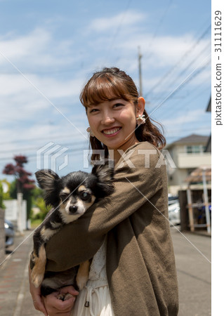 A woman holding a dog A woman holding a dog 31111629