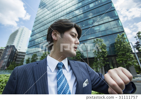 A businessman looking at a watch A businessman looking at a watch 31111757