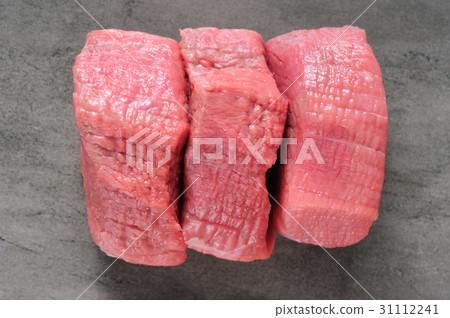 three piecea of raw beef meat on shale board three piecea of raw beef meat on shale board 31112241
