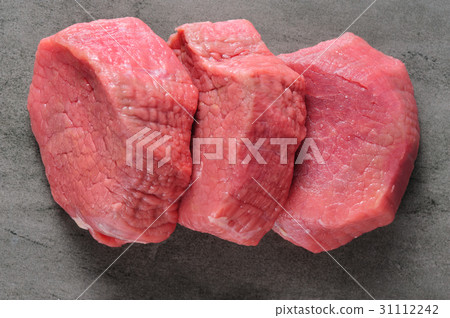 three piecea of raw beef meat on shale board three piecea of raw beef meat on shale board 31112242