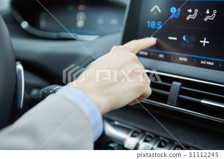 Woman sets up car air conditioning Woman sets up car air conditioning 31112245