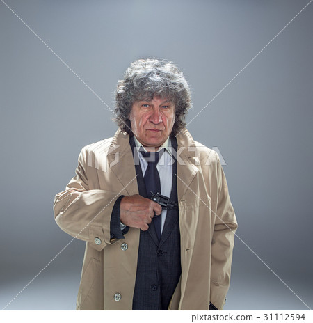 Senior police agent with a gun on studio Senior police agent with a gun on studio 31112594