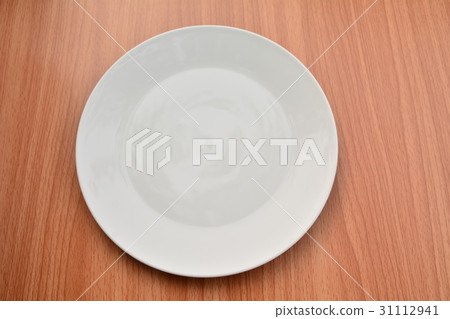 Empty plate on wood table background. Empty plate on wood table background. 31112941