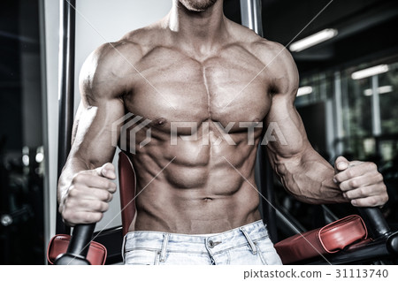 Caucasian sexy fitness model in gym close up abs. 31113740