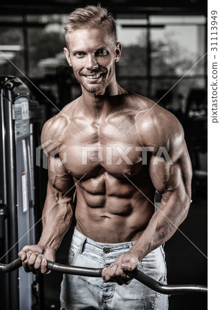 Handsome power athletic man on diet training pumping up muscles 31113949