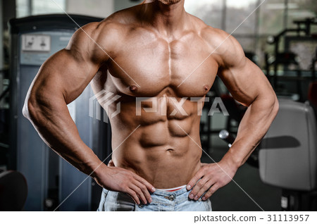 Caucasian sexy fitness model in gym close up abs. 31113957