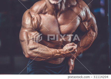 Handsome power athletic man on diet training pumping up muscles Handsome power athletic man on diet training pumping up muscles 31114204